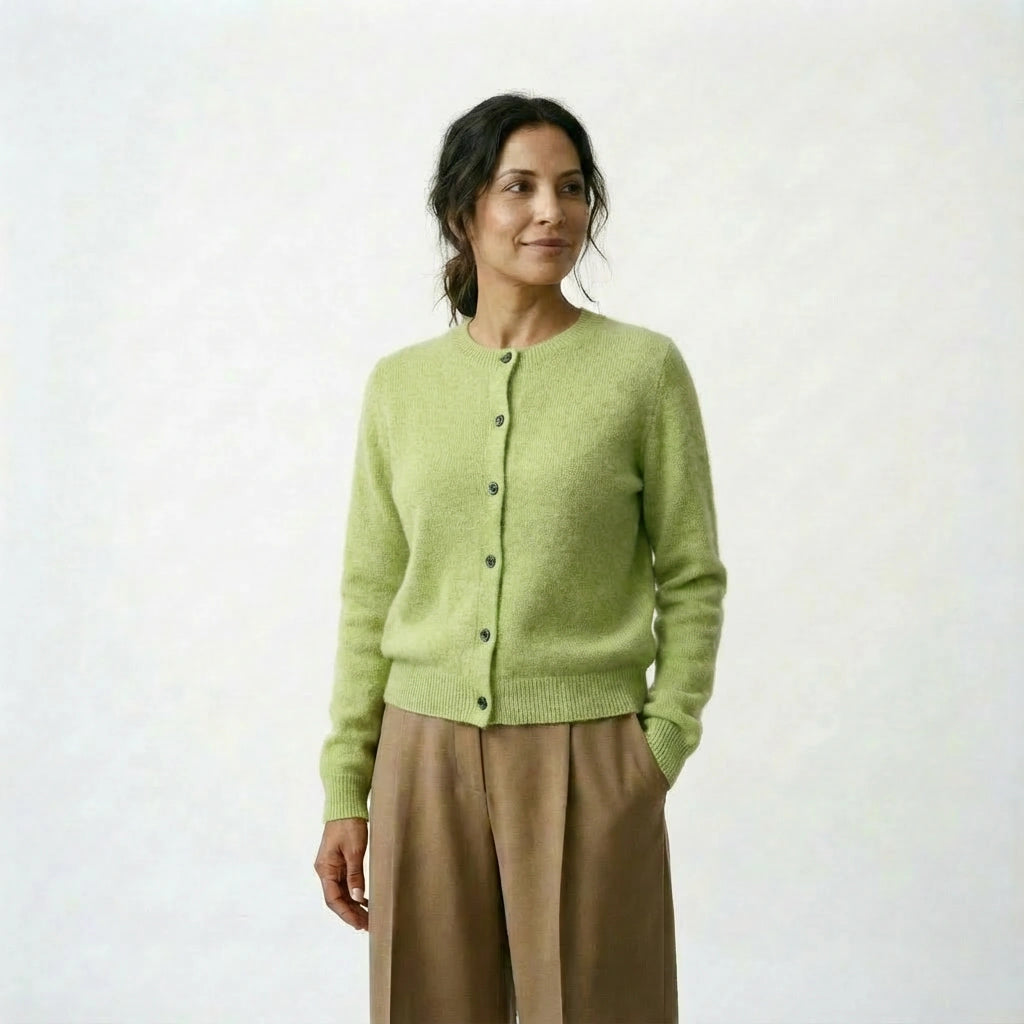 Spanish woman wearing a light green cardigan and beige pants