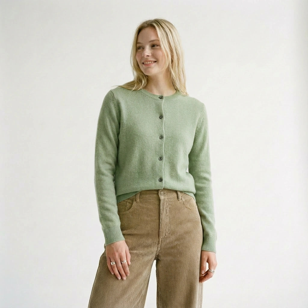 Woman wearing a turquoise green wool cardigan and brown pants