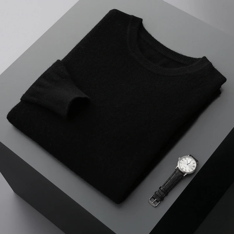 Folded brexton black men's merino wool sweater and watch on a gray surface