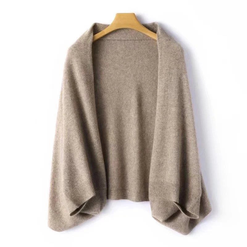 Light brown wool wrap shawl on a wooden hanger against a white background