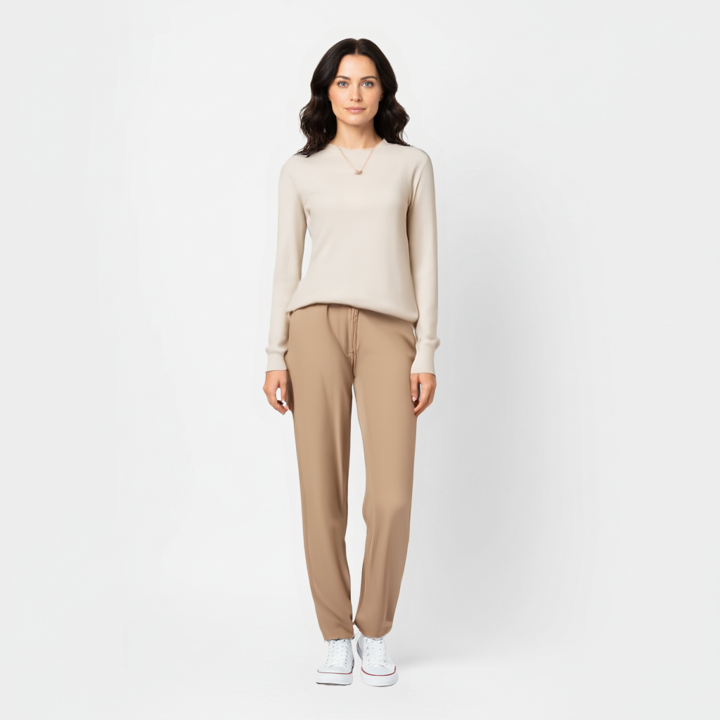 Woman standing wearing beige meredith merino wool sweater for women 