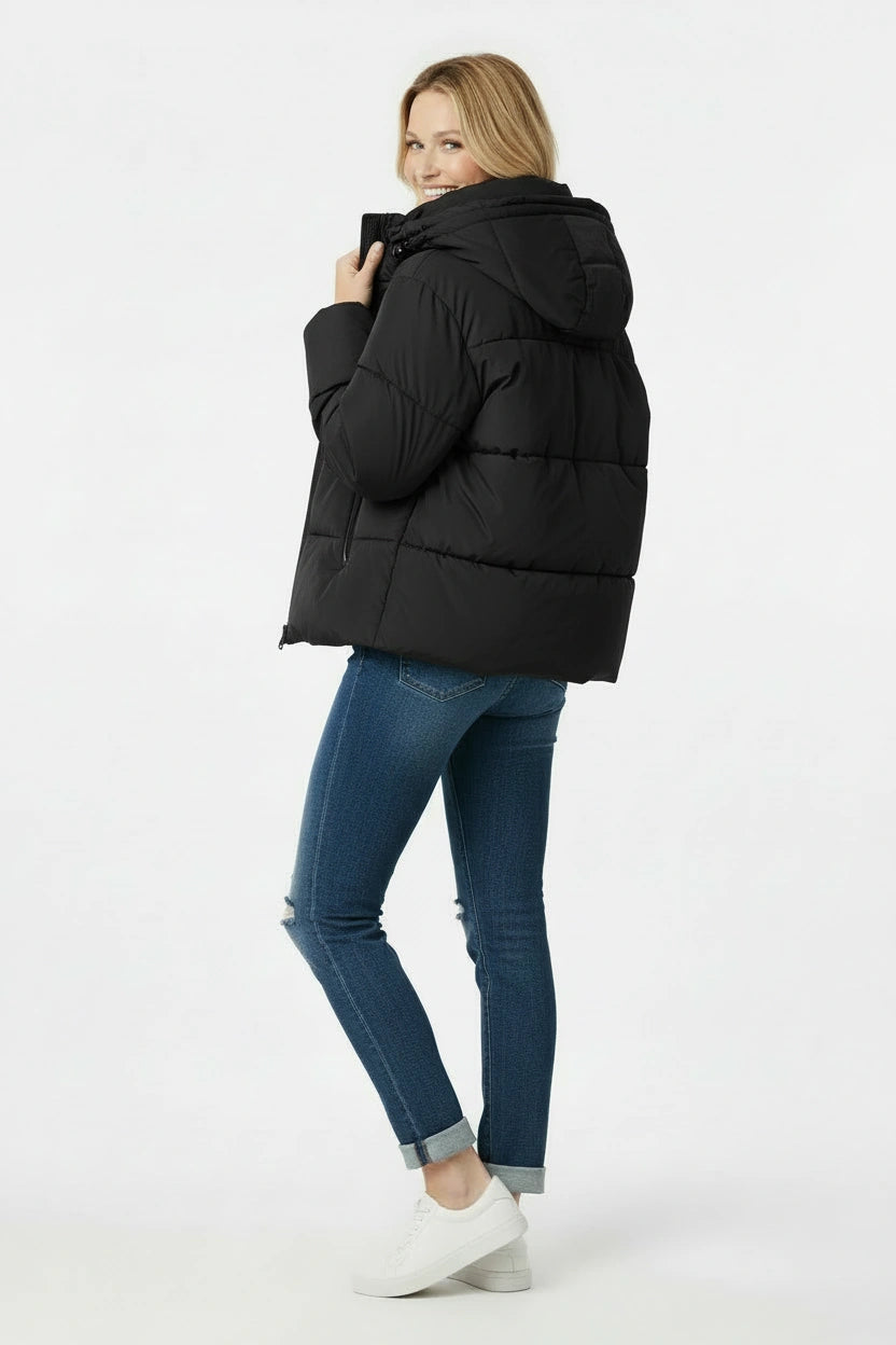 Woman wearing a black puffer jacket on a white background
