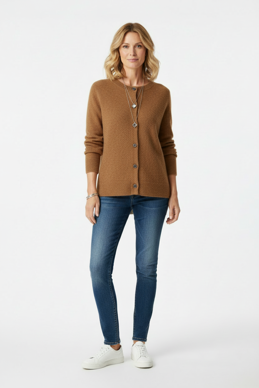 Standing blonde woman wearing a brown cardigan buttoned up